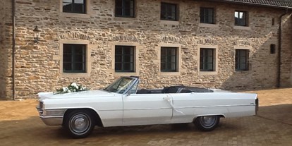 Hochzeitsauto-Vermietung - Marke: Cadillac - PLZ 45356 (Deutschland) - Cadillac de Ville Hochzeitsauto Cabriolet - weiß Ruhrgebiet - Brautauto - Cadillac Weddingcar - Hochzeitsauto & Fotografie